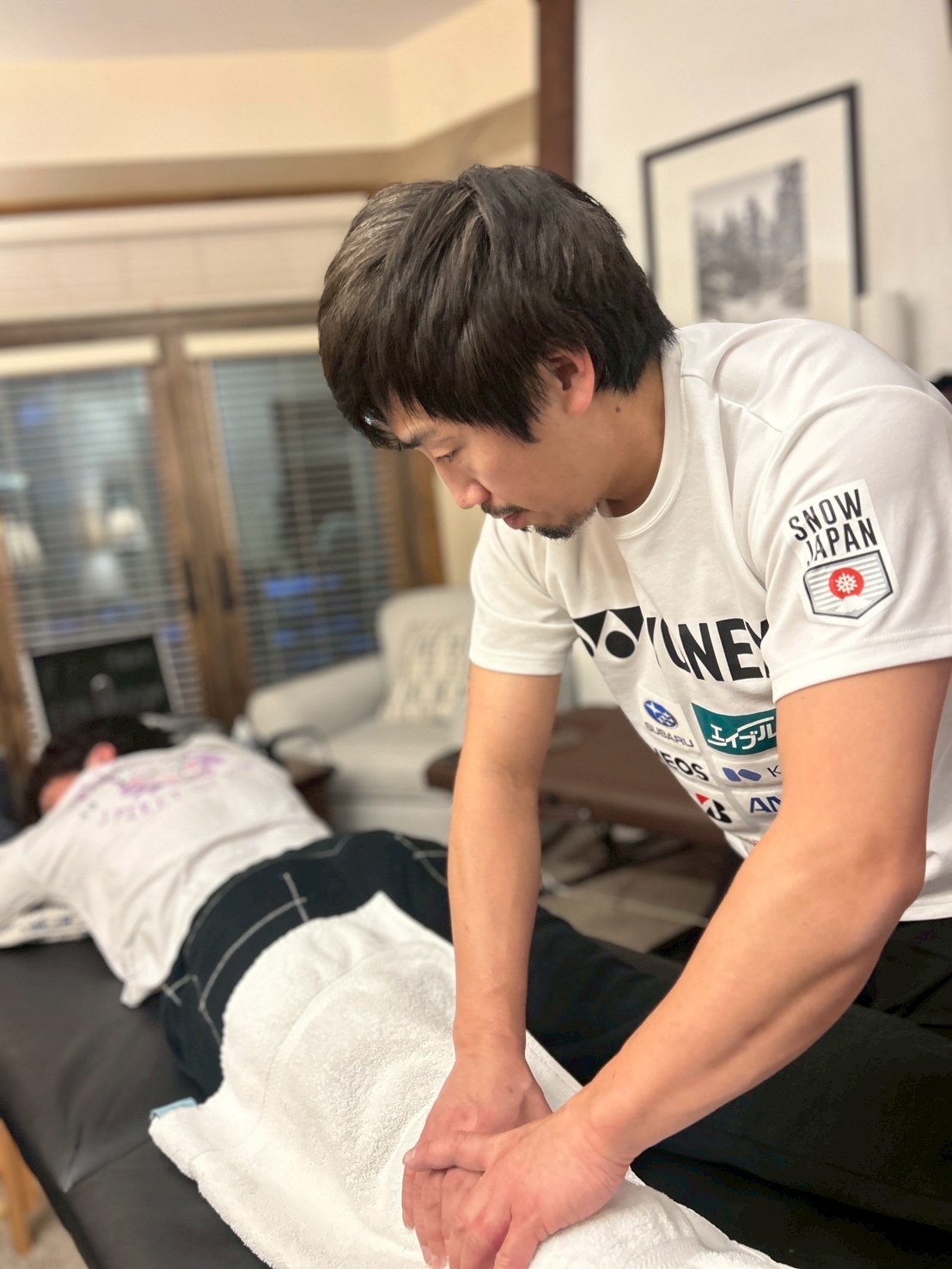 Dr. Shotaro Fukuda treating a Japanese national-team athlete in SNOW JAPAN team gear